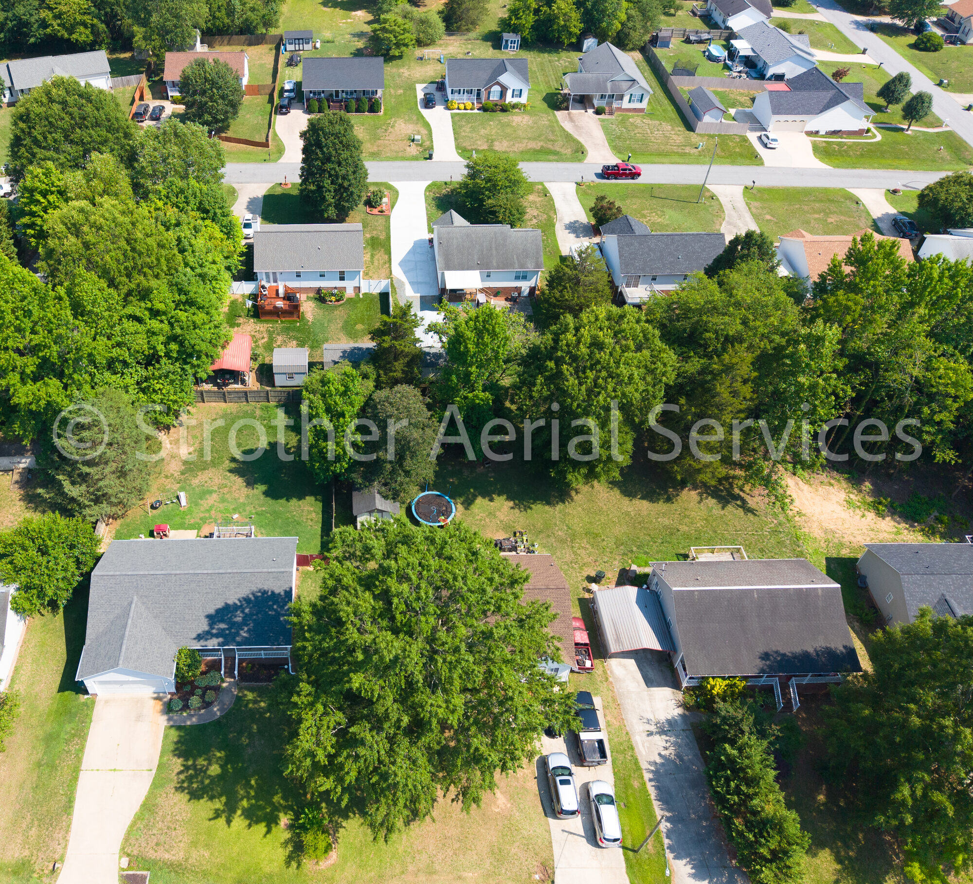Top-down aerial detail of homes and roofs in a residential neighborhood