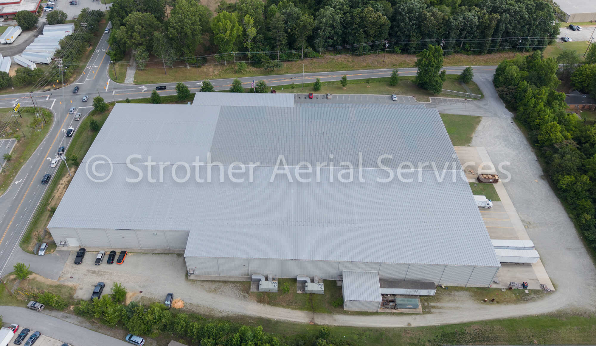 Top-down aerial documentation of a commercial metal warehouse roof